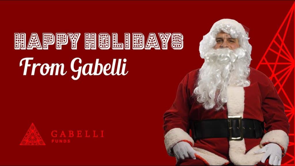 Happy holidays from Gabelli image with a red background and a person dressed as santa clause