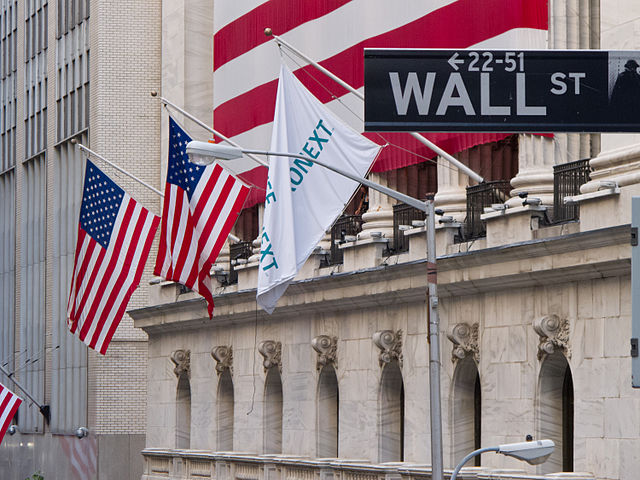 new york stock exchange outside of building and wall street sign
